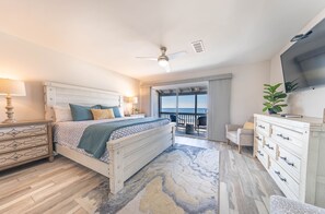 Relax in comfort with a large bed, flat-screen TV, and seating area.