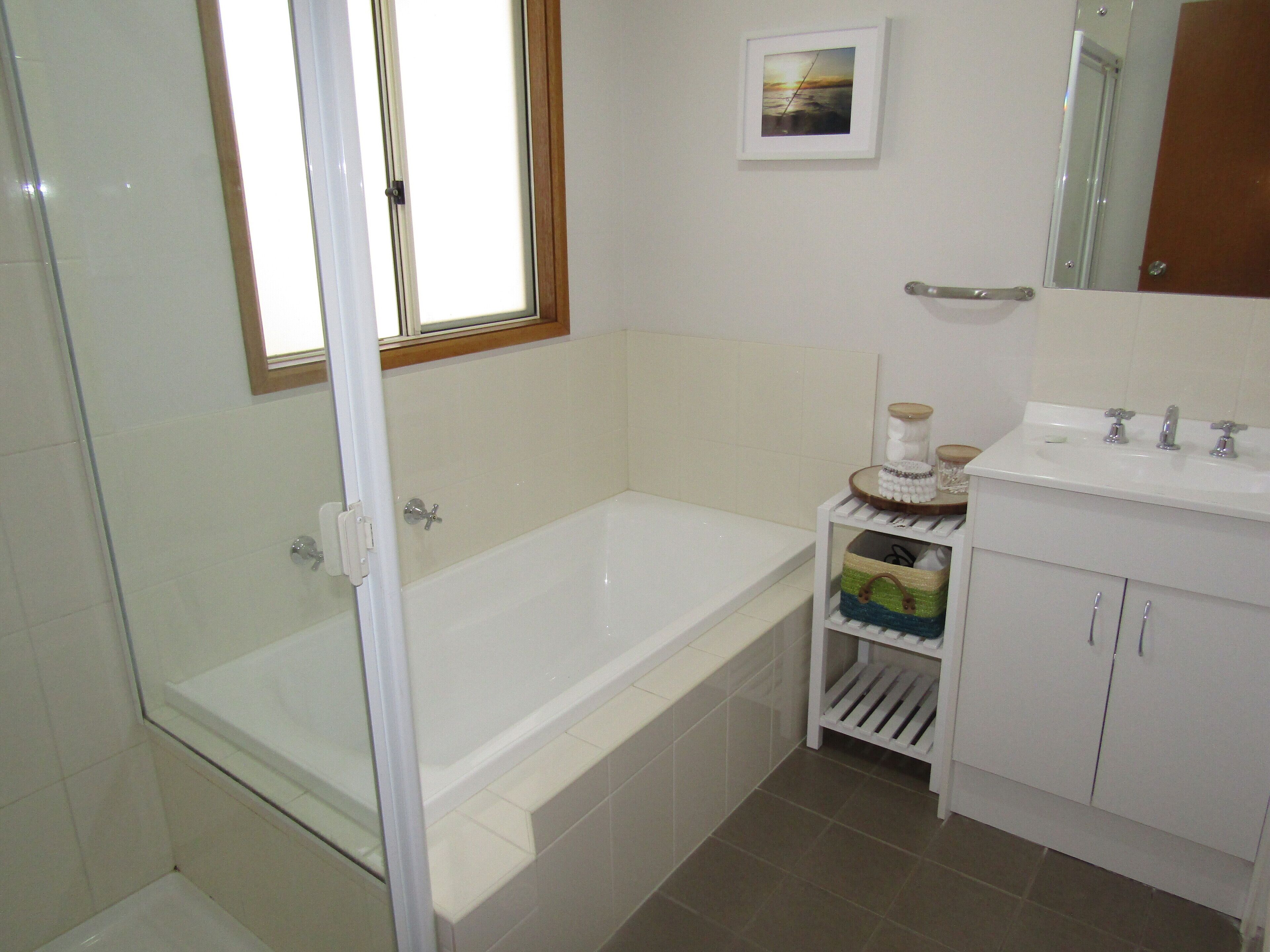 A bathroom with a bathtub, a toilet, and a sink.