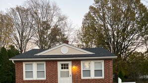 A small brick house with a white picket fence, a mailbox, and a mailbox number 4261. - Private stand-alone little house.   (Fairview Park)