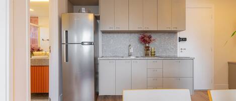 Fridge, microwave, coffee/tea maker, cookware/dishes/utensils