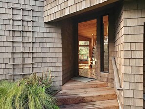 A wooden exterior with a sloped roof and a visible window.