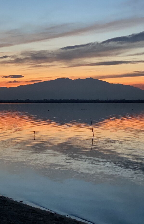 A calm lake with a mountain in the background.