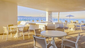 A beachside restaurant with outdoor seating and a view of the ocean. - Chic Oceanfront Studio Loft – Unique Art & Views (Puerto Vallarta)