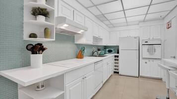 Deluxe Condo | Private kitchen | Full-size fridge, microwave, oven, stovetop