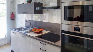 A modern kitchen with a built-in oven, microwave, and stainless steel appliances. - Nice home in Pierre-Châtel with WiFi (Pierre-Châtel)