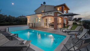 A two-story house with a swimming pool, outdoor seating, and a patio area. - Awesome home in Buzinija with private swimming pool, can be inside or outside (Buzinija)