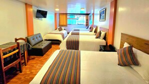 A hotel room with two beds, a sofa, a TV, and a window with curtains. - Amakonkay Machupicchu (Machu Picchu)