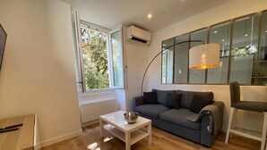 A modern living room with a grey sofa, a white coffee table, and a floor lamp.