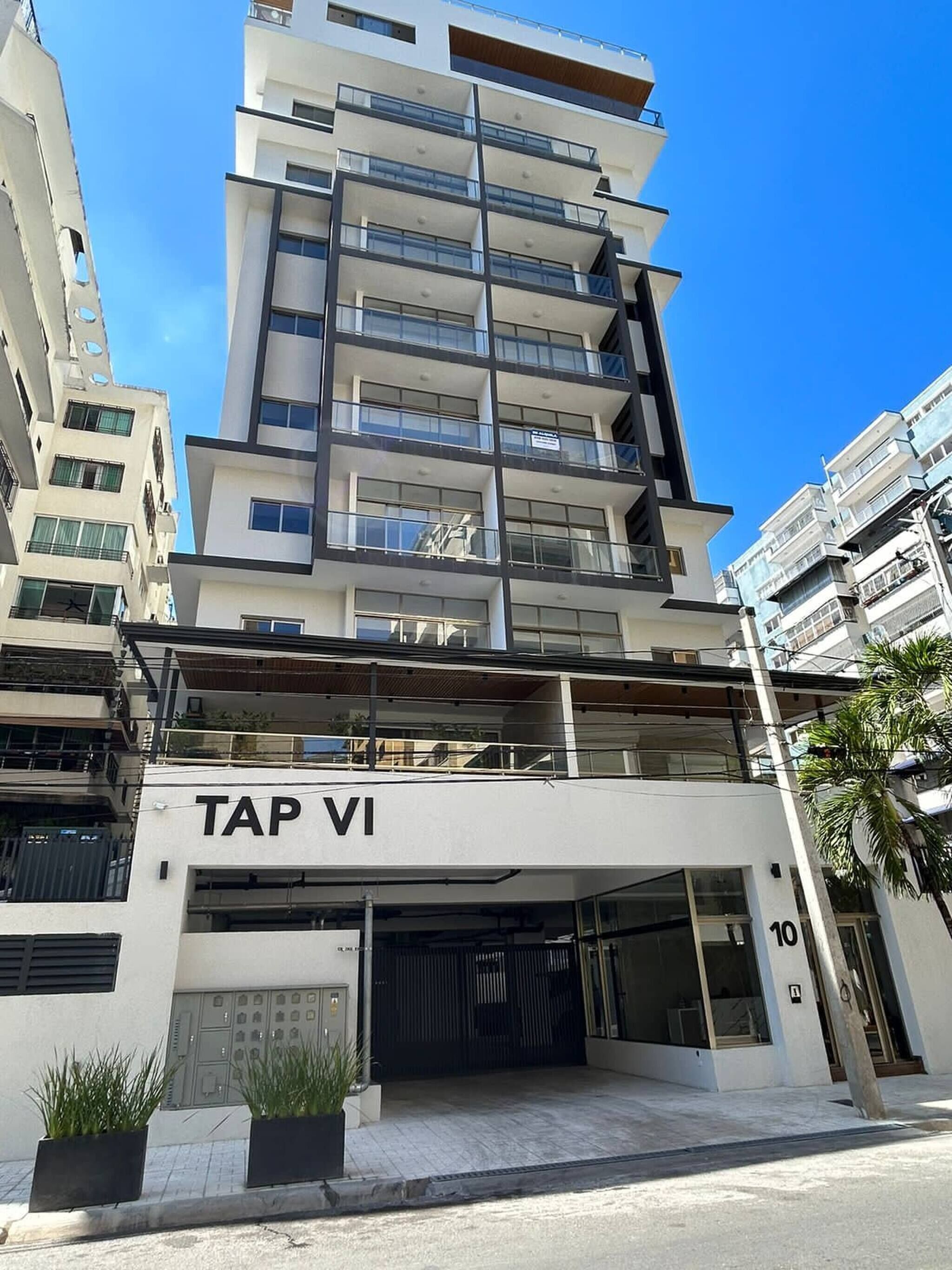 A multi-story building with a sign reading 'TAP VI' at the ground level.