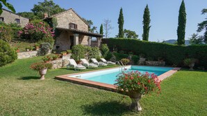 A stone villa with a swimming pool, surrounded by lush greenery and potted plants. - La Vista by Interhome (Vicchio)