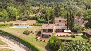 A stone villa with a swimming pool, surrounded by lush greenery and hills. - La Terrazza by Interhome (Vicchio)
