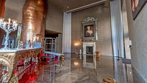 A spacious lobby with a polished marble floor, a grand chandelier, and a large bronze sculpture. - Iconic W Residence Brickell Miami | Massive Amenities Hub (Miami)
