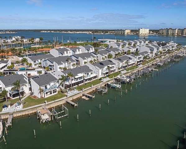 A marina with row houses, docks, and boats.