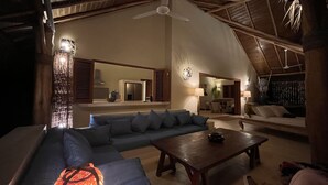 A spacious living area with a high ceiling, a wooden ceiling, a sofa, a coffee table, and a dining area. - Las Terrenas - Caribbean Villa for 6 People - Exceptional Location (Las Terrenas)