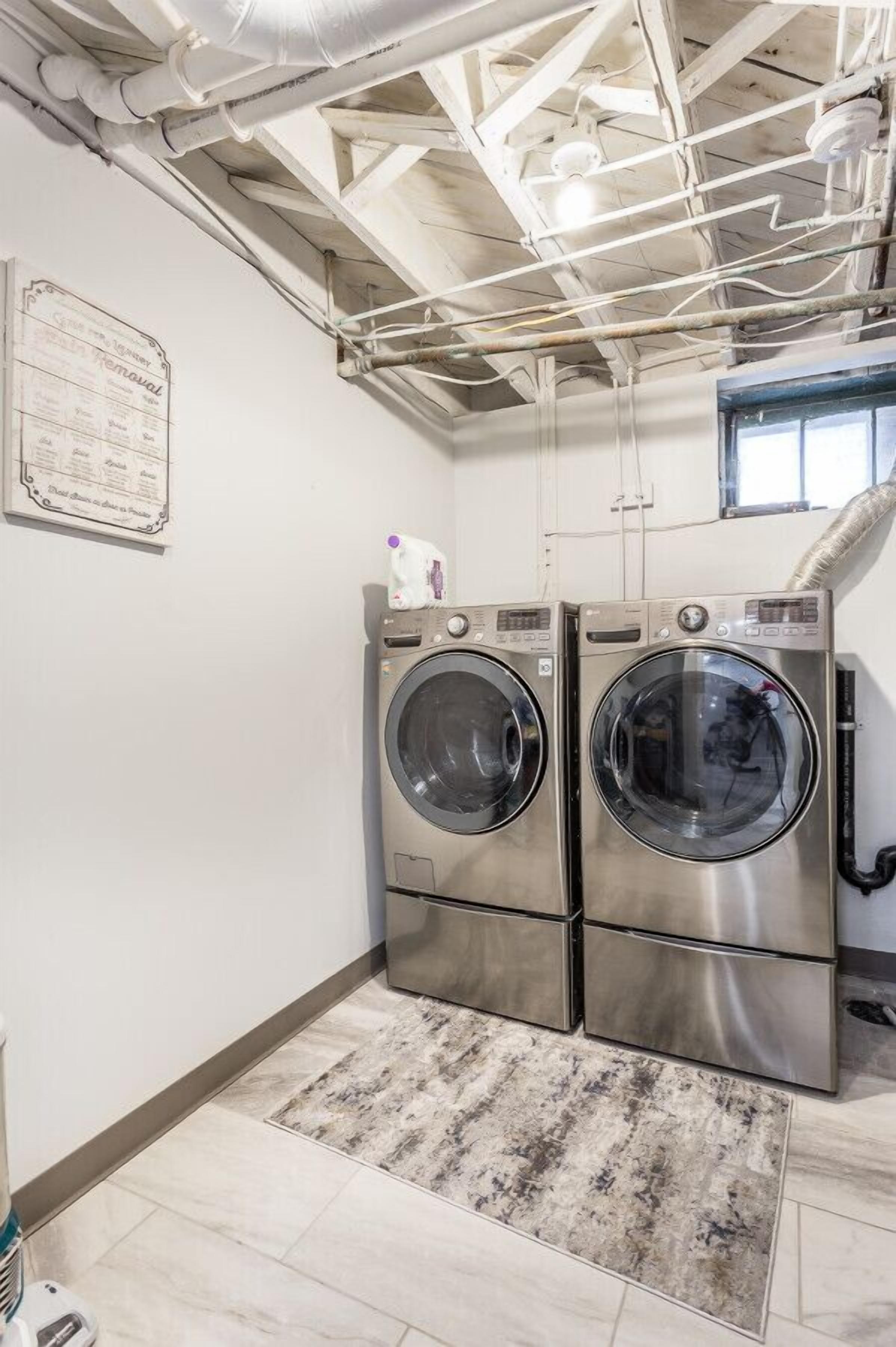 Laundry room with high-efficiency washer and dryer for your convenience.