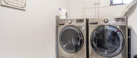 Laundry room with high-efficiency washer and dryer for your convenience.