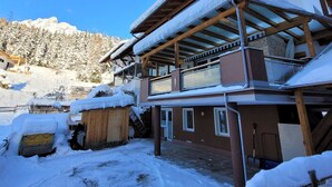 A chalet with a wooden exterior, a balcony, and a snow-covered roof. - Apart Dawin by Interhome (Strengen)