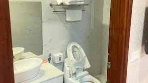 A bathroom with a toilet, sink, and a towel rack. - Ngoc Lan 2 Hotel- by Bay Luxury (Hanoi)