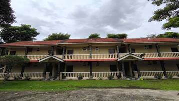 AWANA's elegant facade features a central entrance and two symmetrical wings, supported by ornate columns.