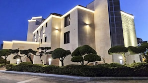 A modern building with a symmetrical facade, multiple windows, and a tall central tower. - Brown Dot Hotel Gyeongju (Gyeongju)