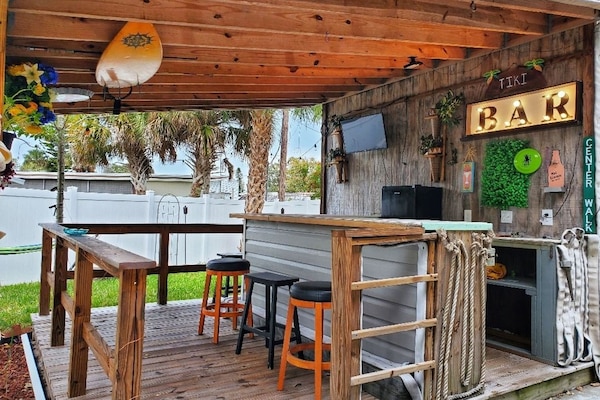 Enjoy watching the game in your own private Tiki Hut bar.