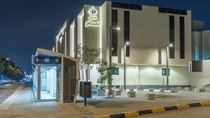 A modern building with a prominent entrance and signage. - Al-Mousafer Hotel Riyadh (Riyadh)