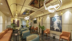 A modern lobby with seating areas, a large abstract painting, and unique lighting fixtures. - The Elite Hotel (Xuan Huong - Da Lat)
