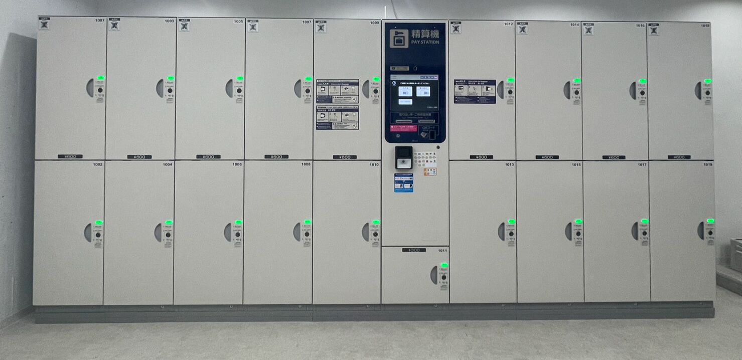 A row of lockers with a central control panel.