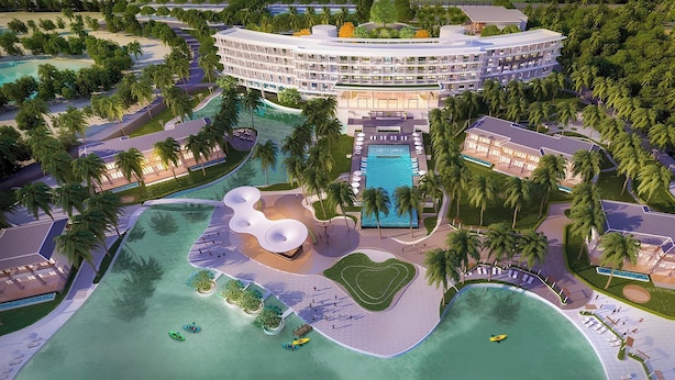 A resort with a central pool, multiple buildings, palm trees, and a beach area. - Emerald Ho Tram Resort (Ho Chi Minh City)