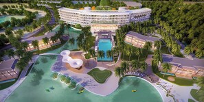 A resort with a central pool, multiple buildings, palm trees, and a beach area. - Emerald Ho Tram Resort (Ho Chi Minh City)