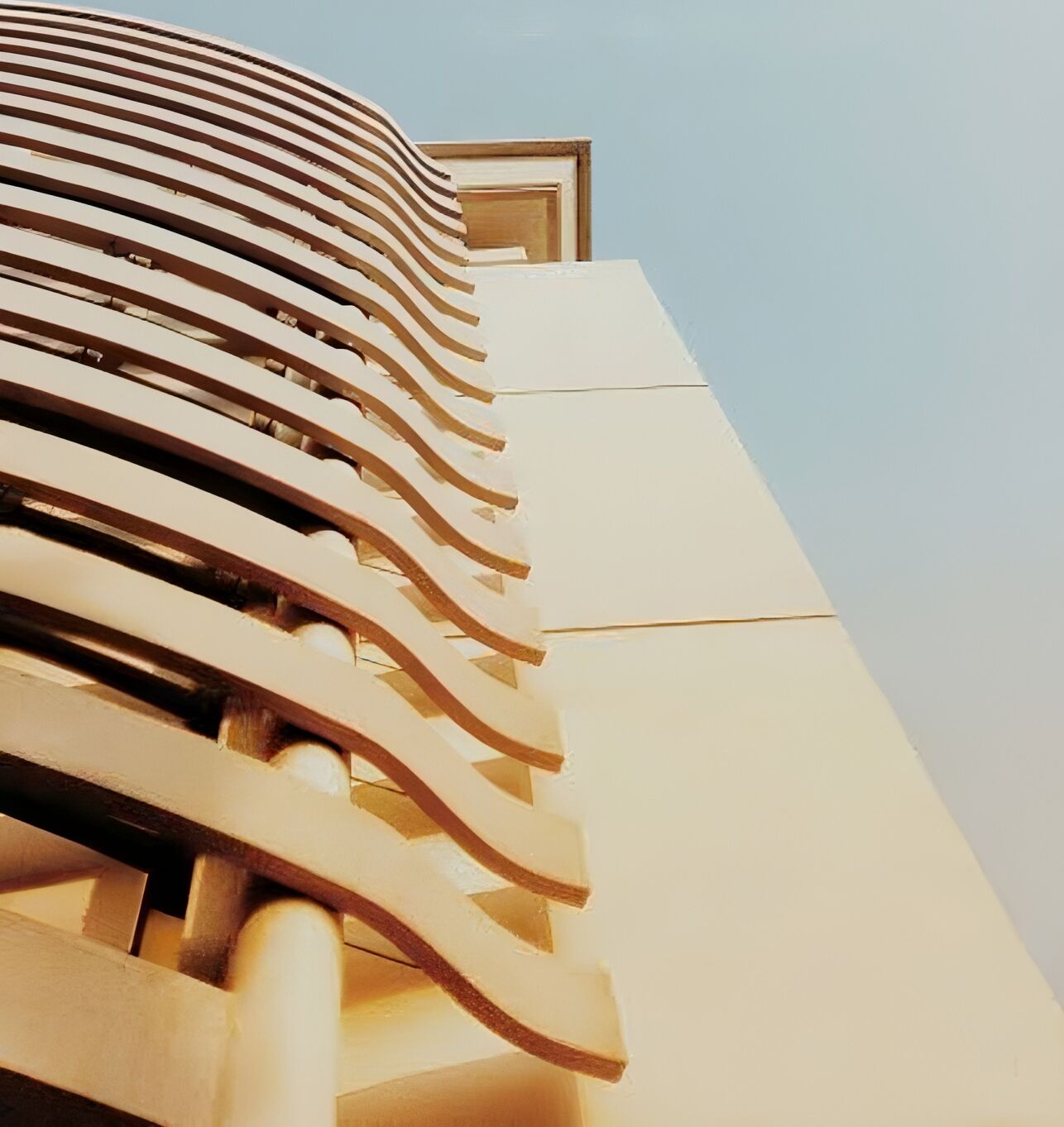 A modern building with a curved facade and a prominent entrance.