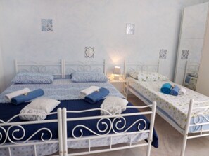 Cozy retreat with a comfortable bed, nightstand, and mirror.