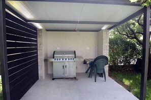 Enjoy al fresco dining with a barbecue grill and outdoor seating area.