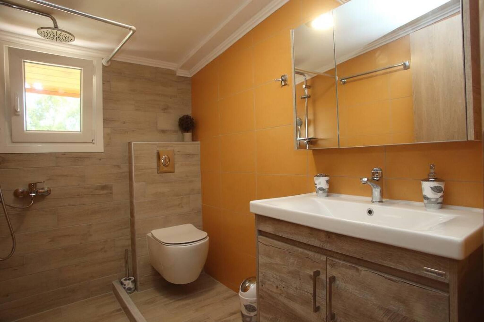 A bathroom with a shower, toilet, and sink.