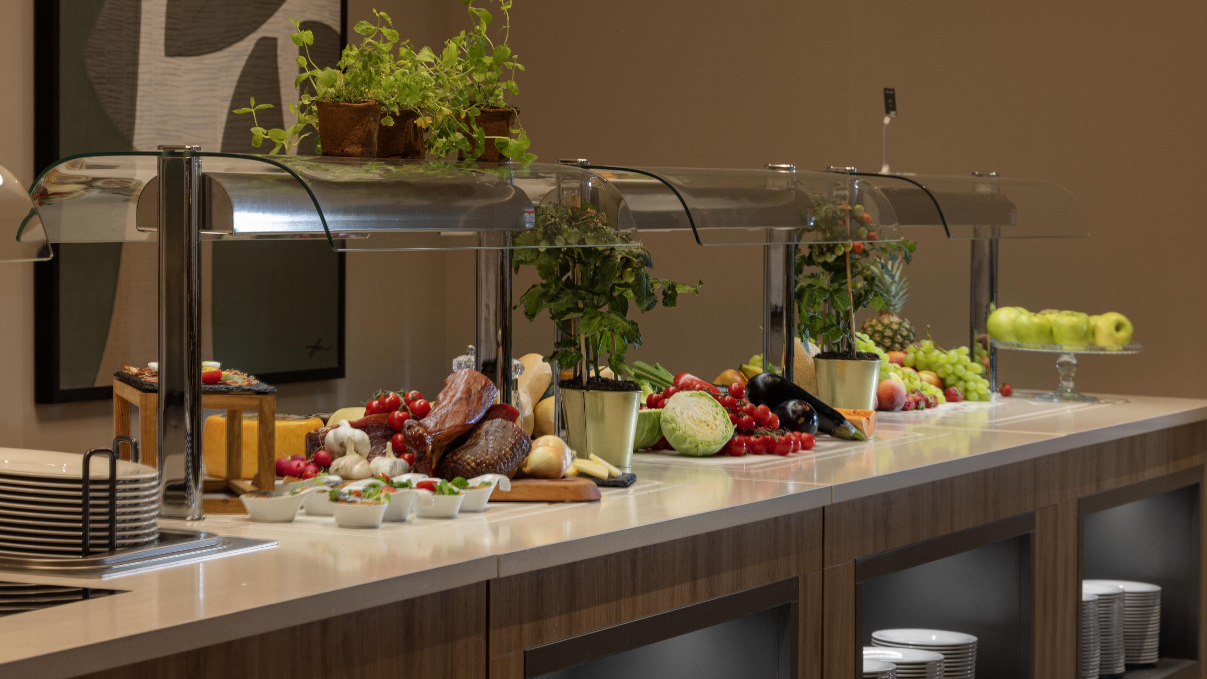 A buffet with various fruits, vegetables, and dishes.