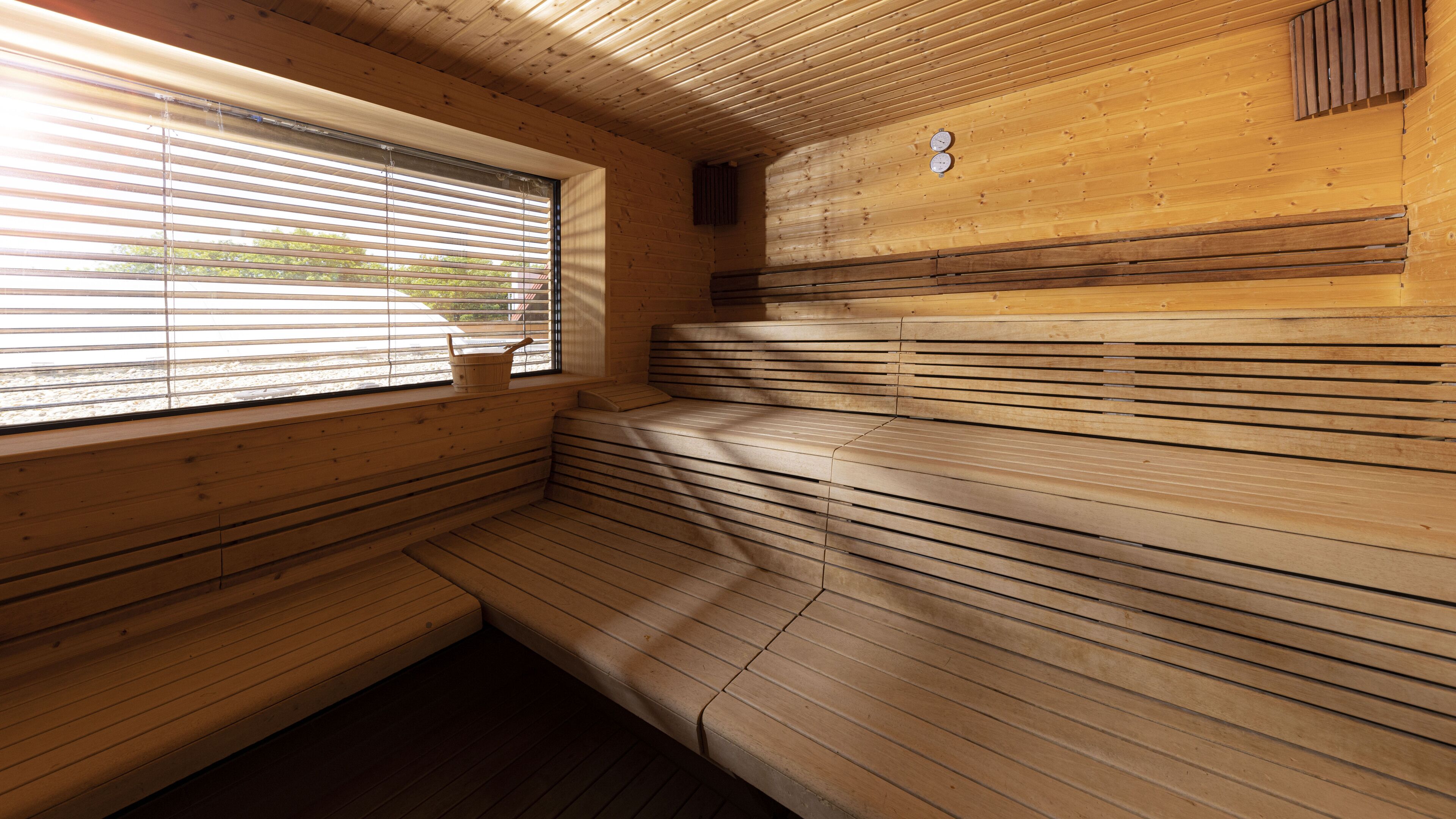 A sauna with wooden benches and a window.