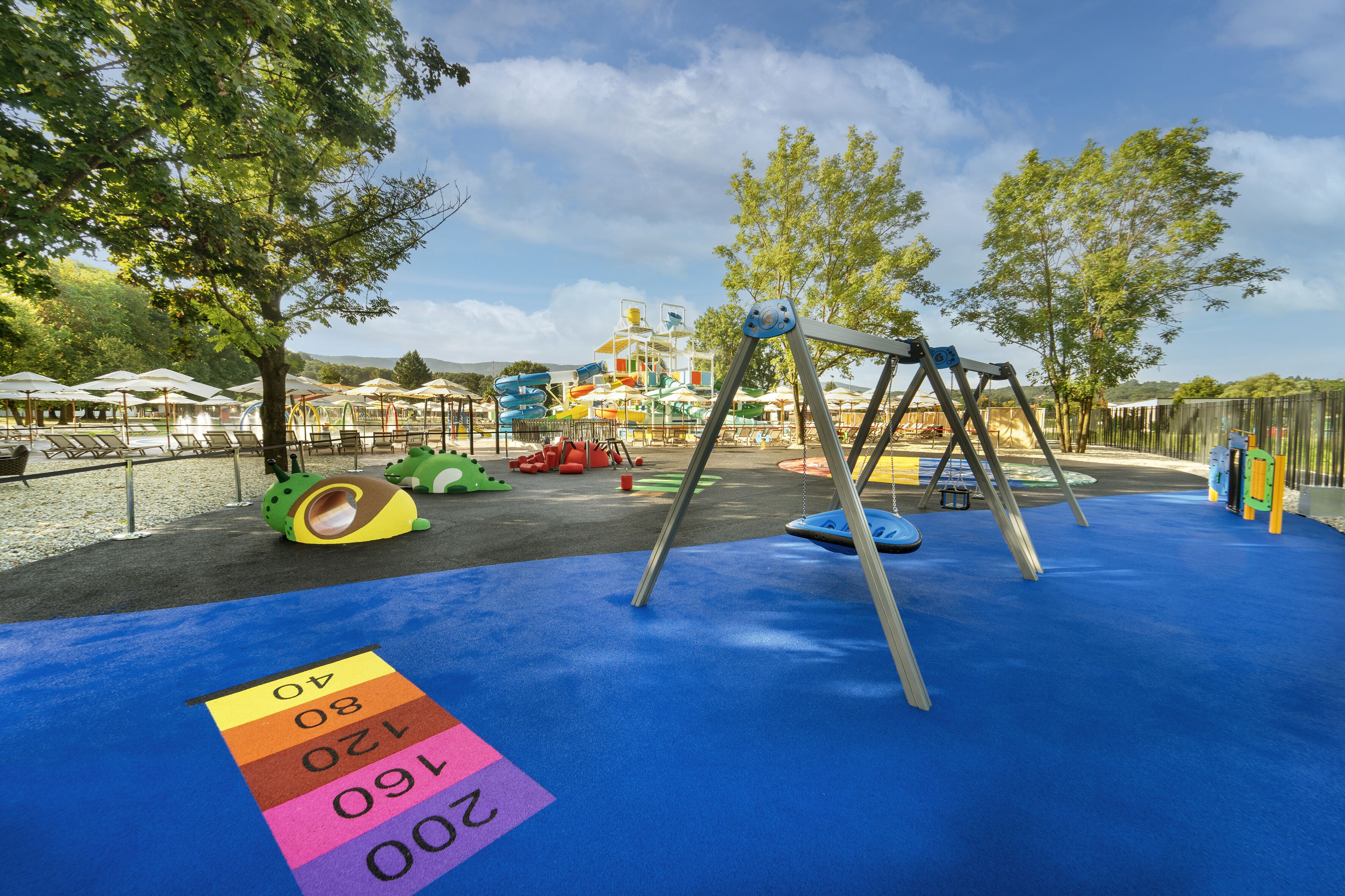 A playground with a swing set, slides, and a climbing structure.
