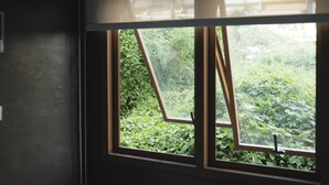 Una ventana con vista a follaje exterior.