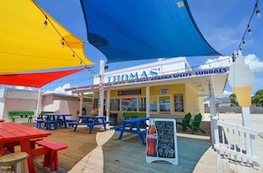 A beachside restaurant named 'THOMAS' with outdoor seating and a Coca-Cola sign. - Laid Back In Laguna - Pet Friendly, Private Pool (Panama City Beach)