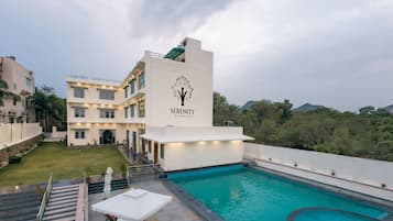 Relax by the resort's swimming pool surrounded by a spacious deck area.