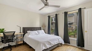 A bedroom with a bed, desk, chair, and a ceiling fan. - 10 Mins to Downtown, 4BR + Game Room + 3 Baths (Pittsburgh)