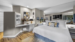 A modern bedroom with a large bed, a desk, and a built-in wardrobe. - New Listing! Mt. Bachelor Village Condo ~ Views (Bend)