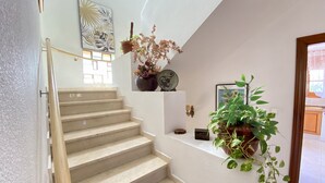 A staircase with beige steps, a white wall, and a window with a geometric pattern. - Magnifica Villa 5 Bed La Font With Private Pool (Sant Joan d'Alacant)