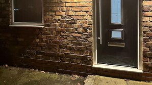 A brick exterior with a dark-colored door and a window. - Immaculate 4-bed Detached House in Bootle (Bootle)