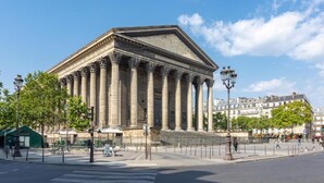 A classical building with a symmetrical facade, large columns, and a central pediment. - Sweett | Madeleine VI (Paris)