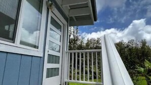 A house with a wooden deck and a white railing.