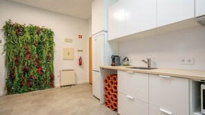 Enjoy cooking in this well-equipped kitchen with a counter, sink, and coffee machine.