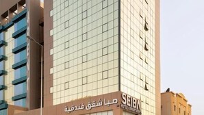 A modern hotel building with a glass facade and a sign indicating it is a hotel. - Seiba Serviced Apartments- Riyadh (Riyadh)
