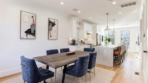 A modern kitchen with white cabinets, a central island, and pendant lighting. - Newly Built 3BR Home in Alexandria-Walk to Metro!

 (Alexandria)