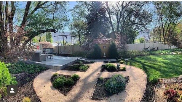 A backyard with a patio, a small garden, and a lawn. - ALL NEW - Clean & Modern! Mountain Garden Oasis! (Ogden)
